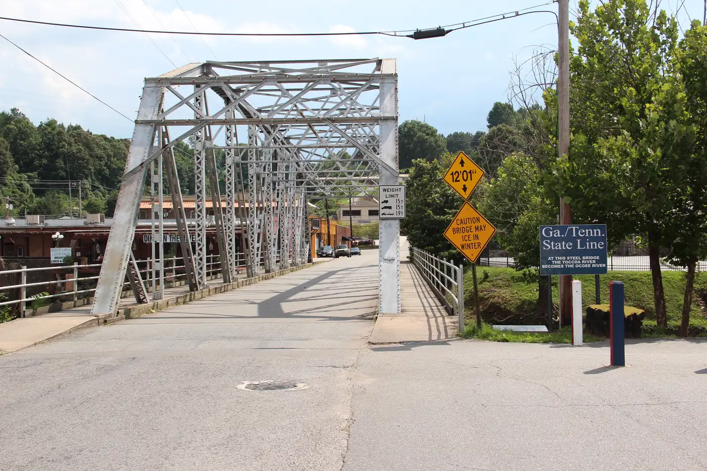 Steel truss road bridge with a Ga./Tenn. State Line sign at its entrance